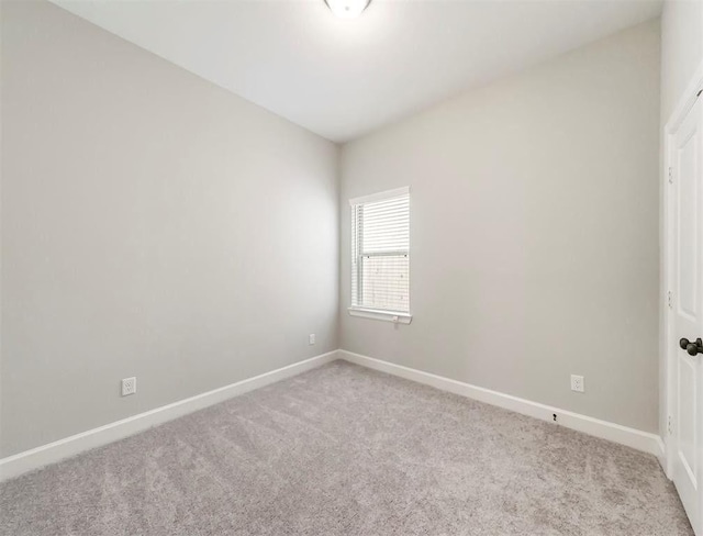 unfurnished room with light carpet