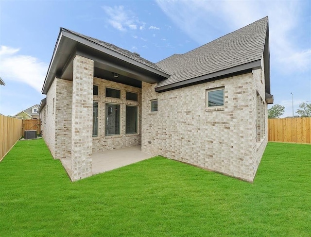 back of house with a patio area, central AC, and a lawn