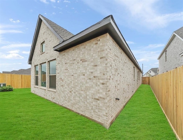 view of side of property with a yard