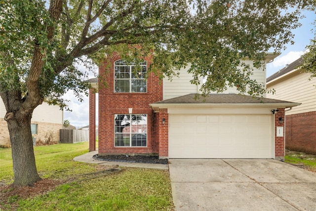 view of property featuring a garage and a front lawn