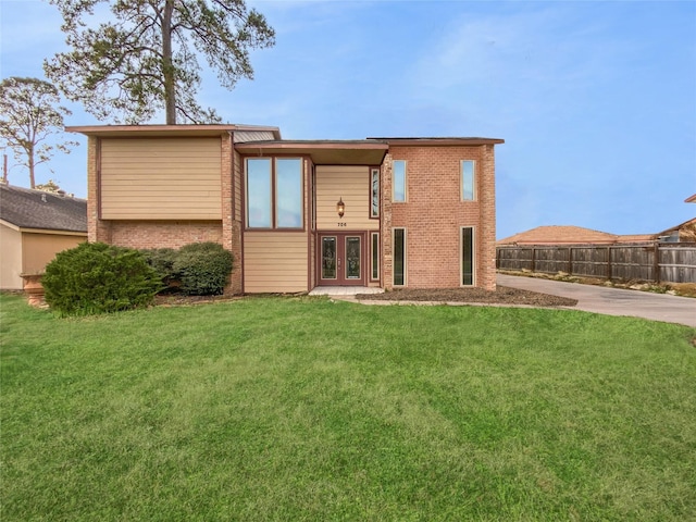 rear view of house with a lawn