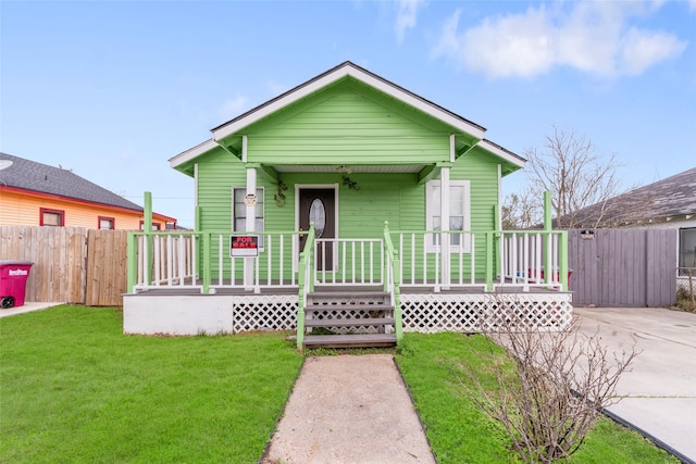 bungalow-style home featuring a front yard and covered porch