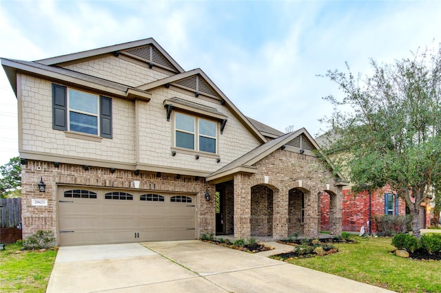 craftsman-style house featuring driveway, brick siding, a front lawn, and an attached garage