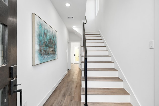 stairway with hardwood / wood-style flooring