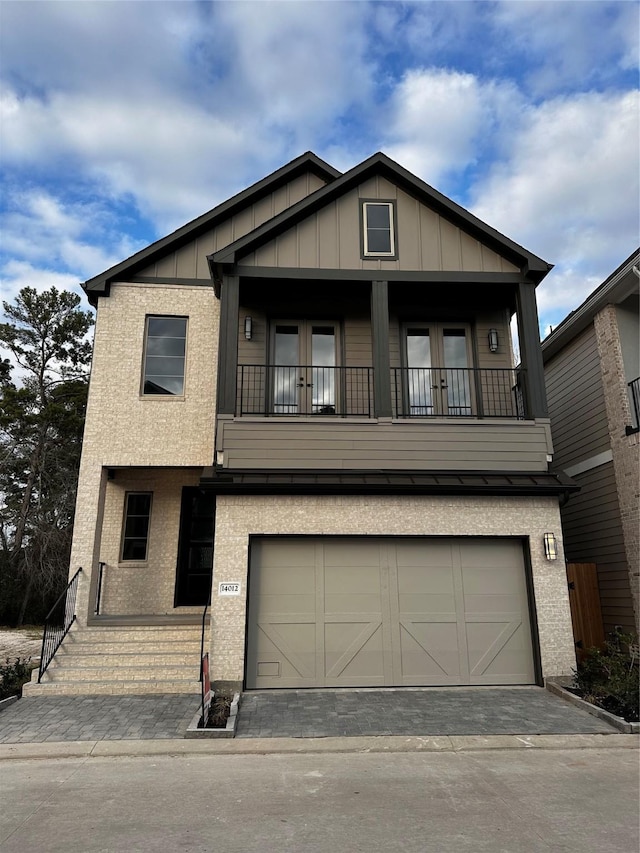 view of front of home featuring a garage and a balcony