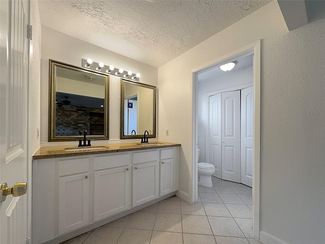 15815 La Cabana Dr, Houston, TX 77062 - bathroom with vanity, toilet, tile patterned flooring, and a textured ceiling