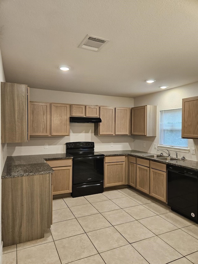 kitchen with sink, a textured ceiling, light tile patterned floors, dark stone counters, and black appliances