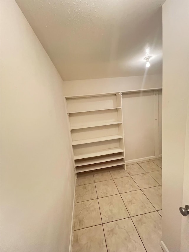 spacious closet featuring light tile patterned floors