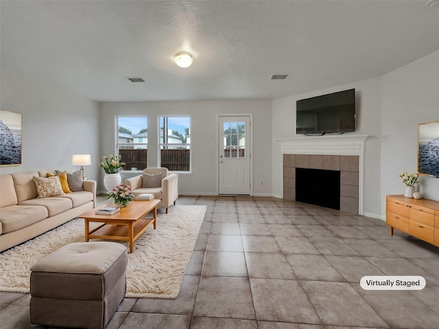 living room with a textured ceiling and a fireplace