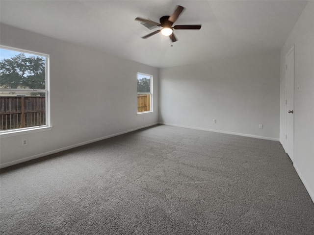 carpeted spare room featuring ceiling fan