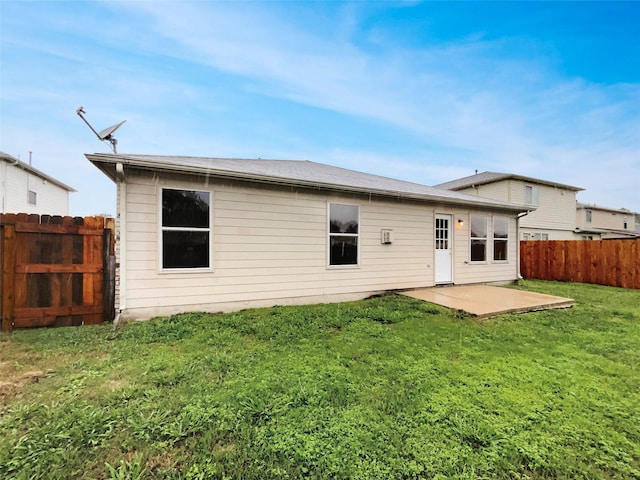 back of house with a yard and a patio area