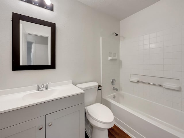 full bathroom with vanity, tiled shower / bath combo, wood-type flooring, and toilet