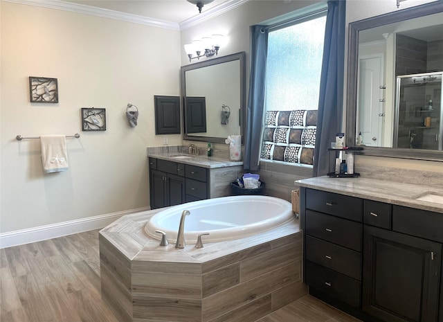 bathroom featuring independent shower and bath, crown molding, wood-type flooring, and vanity