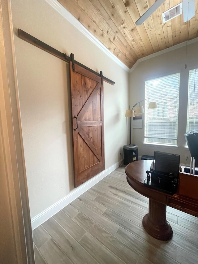 office featuring wood ceiling, crown molding, ceiling fan, a barn door, and light hardwood / wood-style floors