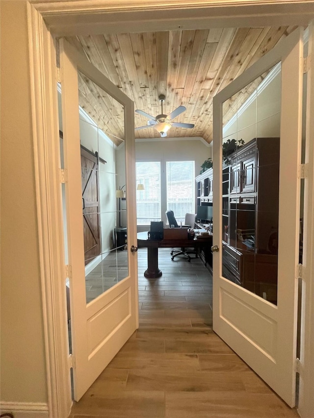 hall featuring wood ceiling, wood-type flooring, and a barn door