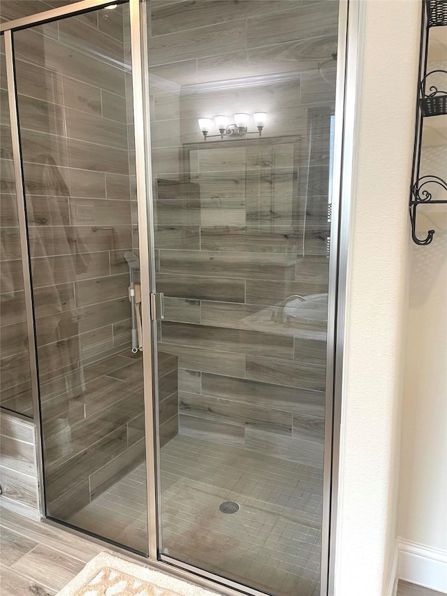 bathroom featuring a shower with shower door