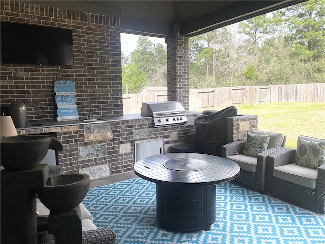 view of patio / terrace with exterior kitchen, grilling area, and a bar