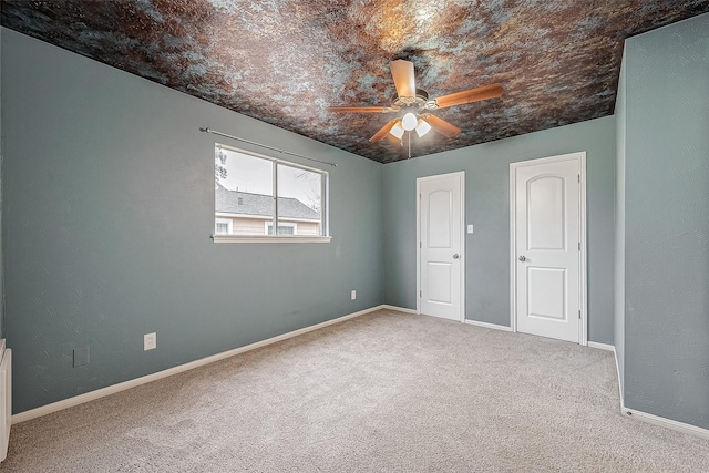 unfurnished bedroom with ceiling fan and carpet floors