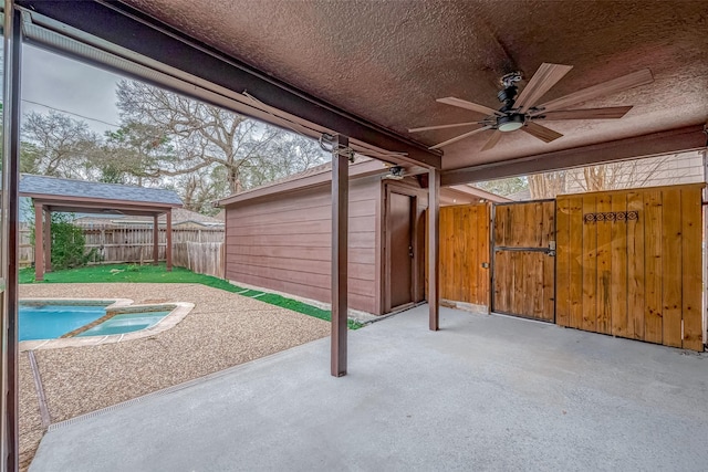 view of patio / terrace featuring a fenced in pool and ceiling fan