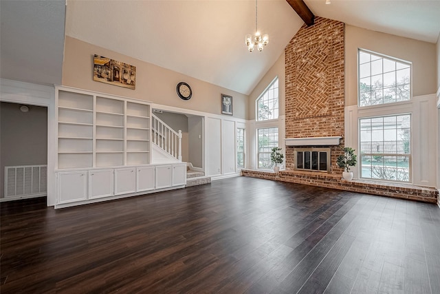 unfurnished living room featuring plenty of natural light, dark hardwood / wood-style flooring, high vaulted ceiling, and a brick fireplace