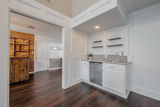 kitchen with dishwasher, sink, light stone countertops, and white cabinets