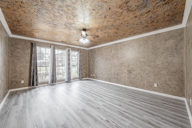 empty room with hardwood / wood-style floors, ornamental molding, and ceiling fan