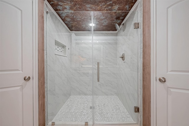 bathroom featuring a shower with door