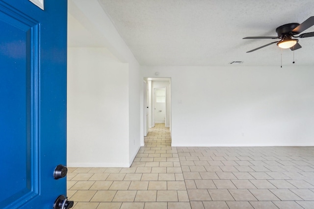 unfurnished room featuring a textured ceiling and ceiling fan