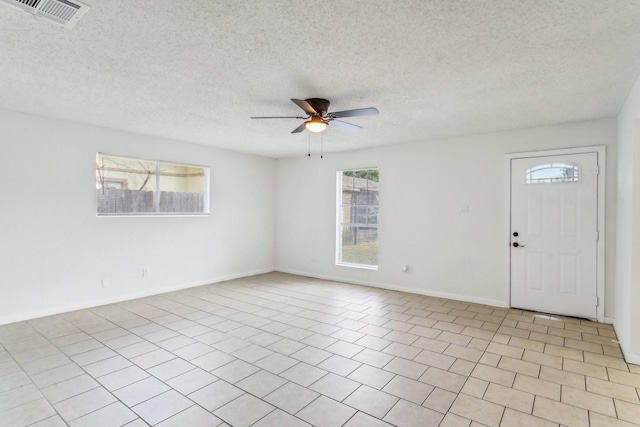 unfurnished room with a textured ceiling and ceiling fan