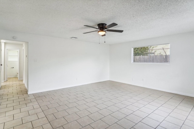 unfurnished room featuring ceiling fan, a textured ceiling, and light tile patterned floors