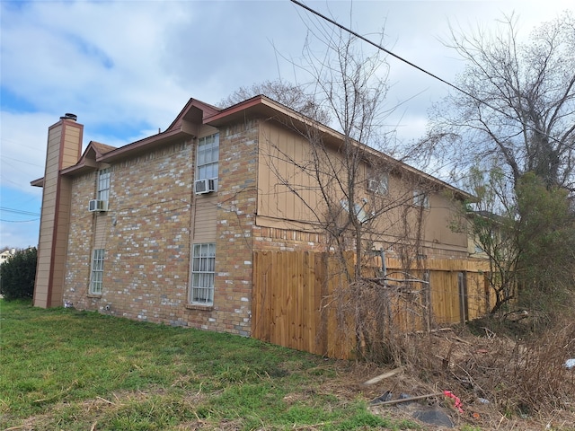 view of home's exterior with a yard and cooling unit