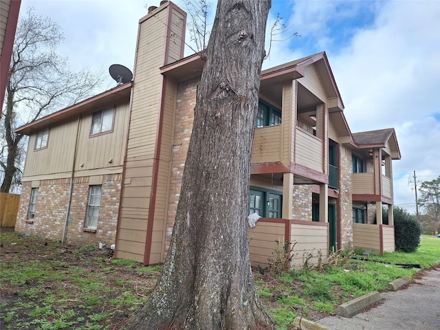 view of home's exterior with a balcony