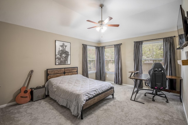 bedroom featuring multiple windows, light carpet, and ceiling fan