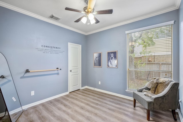 sitting room with ornamental molding, ceiling fan, and light hardwood / wood-style flooring