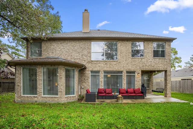 rear view of property featuring an outdoor living space, a yard, and a patio area