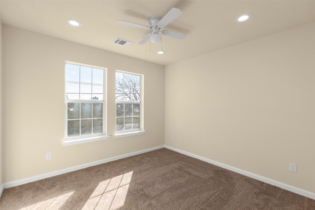 spare room featuring ceiling fan and carpet flooring