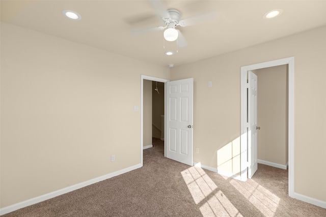 unfurnished bedroom with light colored carpet and ceiling fan