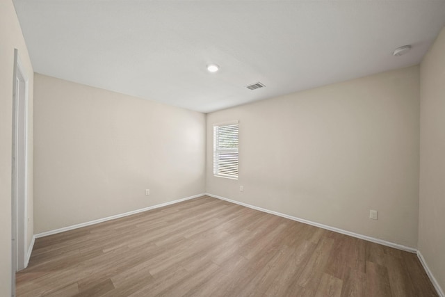 unfurnished room with light wood-type flooring