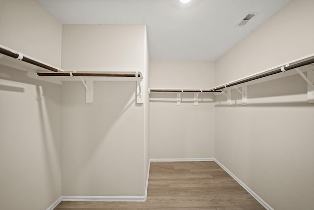 spacious closet with light hardwood / wood-style flooring