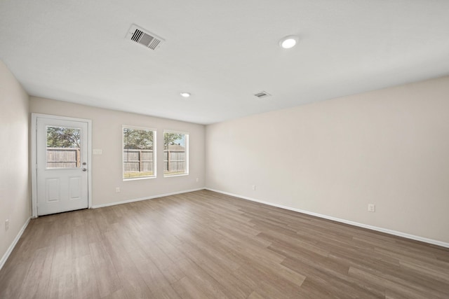 spare room with light hardwood / wood-style floors