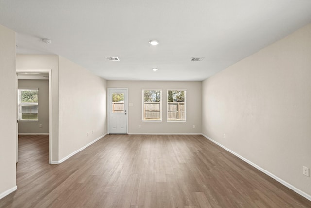 unfurnished room with hardwood / wood-style flooring