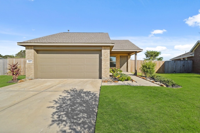 view of front of house featuring a garage and a front lawn