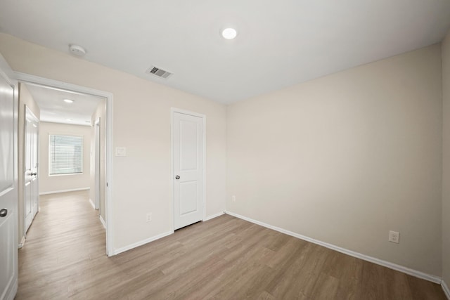 spare room with light hardwood / wood-style flooring