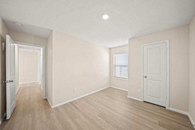 spare room with light hardwood / wood-style flooring