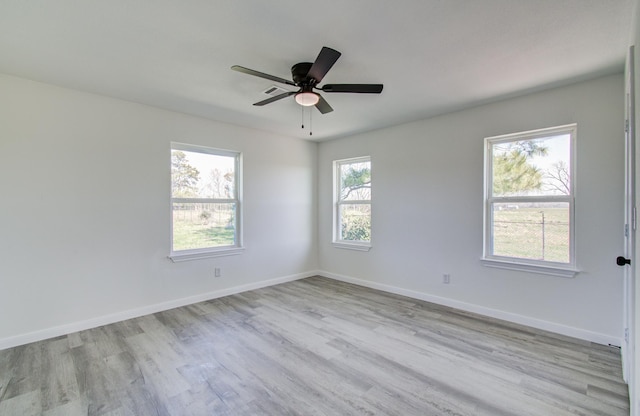 spare room featuring ceiling fan and light hardwood / wood-style flooring