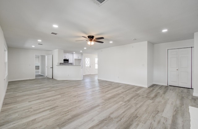 unfurnished living room with light wood-type flooring and ceiling fan