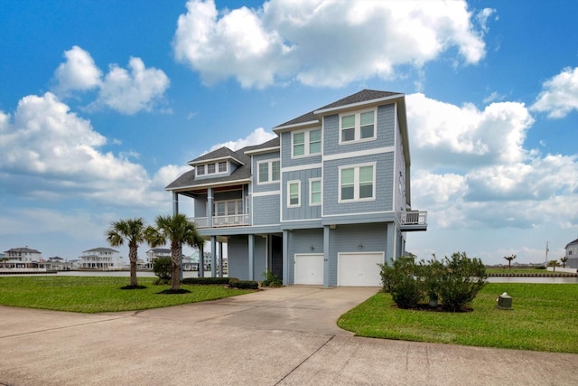 view of front of home featuring a water view, a balcony, a garage, and a front yard