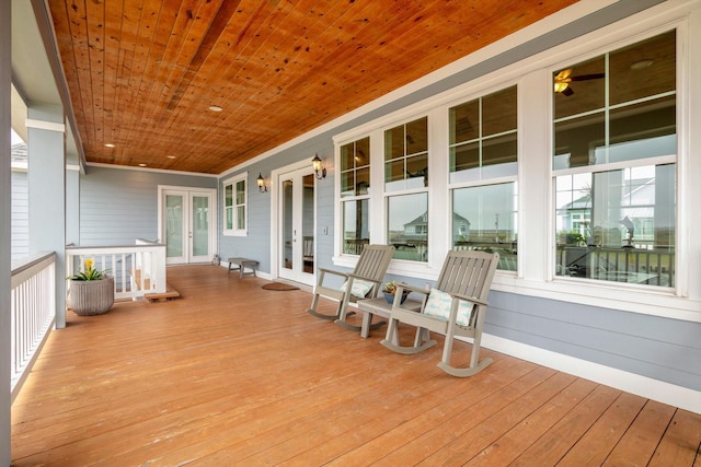 wooden deck featuring covered porch and french doors