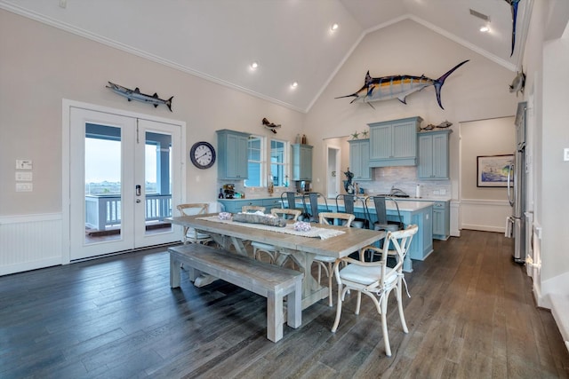 dining room featuring french doors, dark hardwood / wood-style flooring, high vaulted ceiling, and crown molding