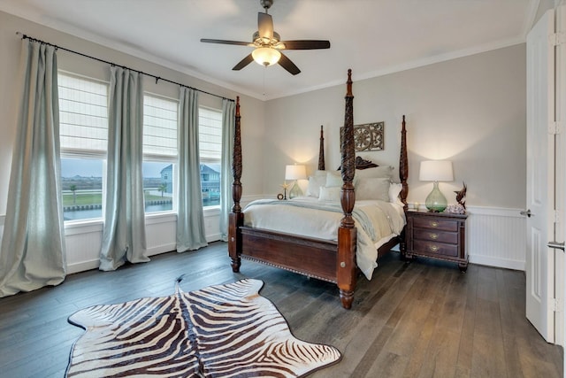 bedroom with dark hardwood / wood-style flooring, ornamental molding, and ceiling fan